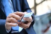 Close up of a man using mobile smart phone 